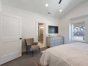 Spacious room featuring vaulted ceilings, recessed lighting, and large windows
