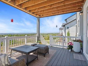 Covered outdoor deck with grey composite flooring and white railing
