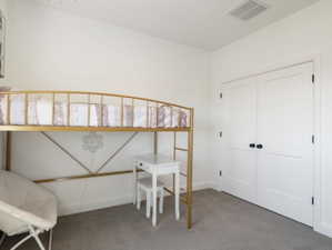 White interior walls with a gray carpeted floor