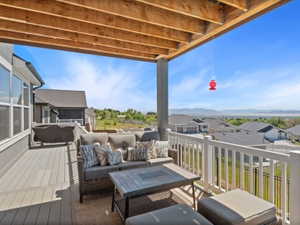 Covered outdoor deck featuring composite decking and white railings