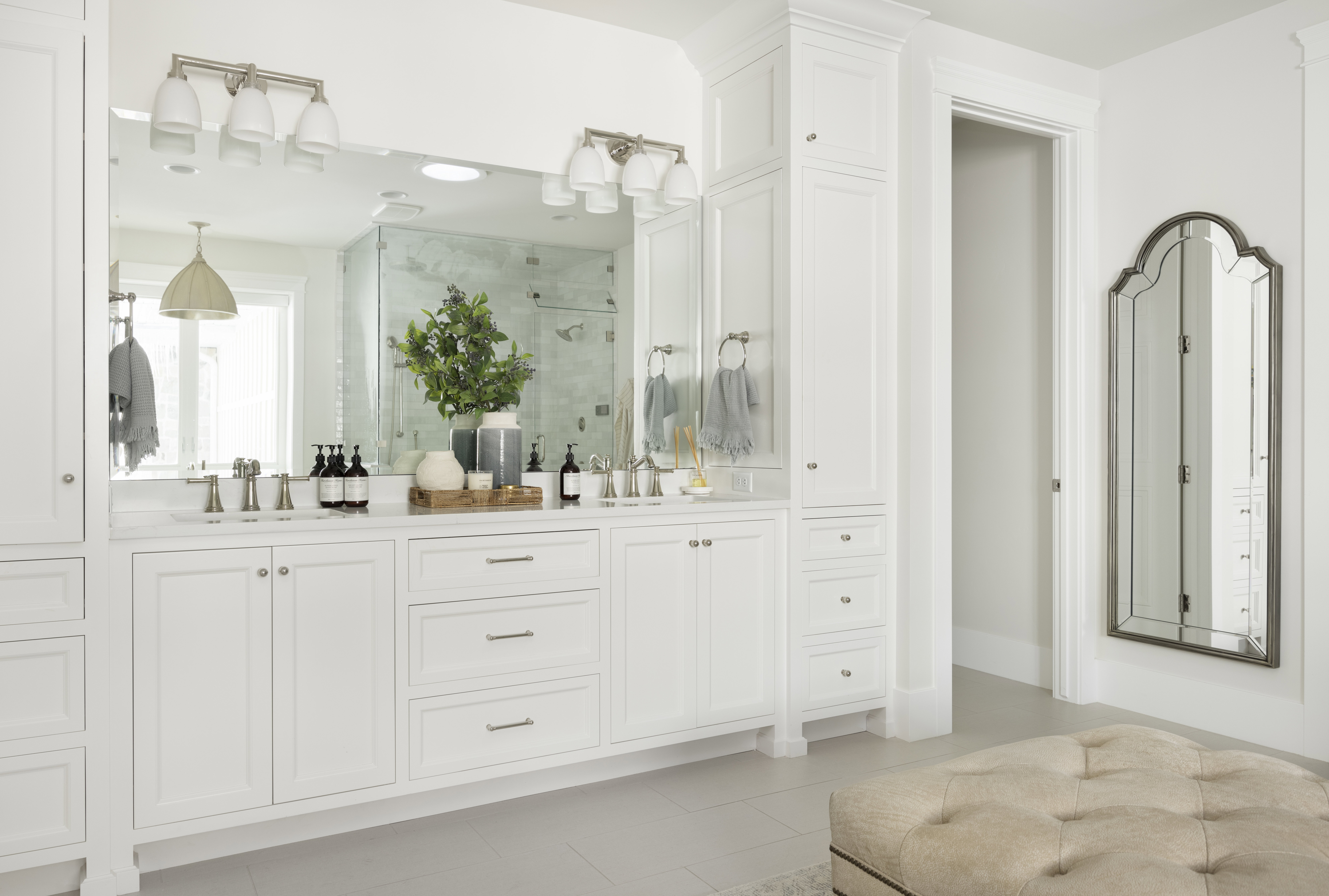 Dual vanity with white cabinetry, brushed nickel hardware, and a quartz countertop