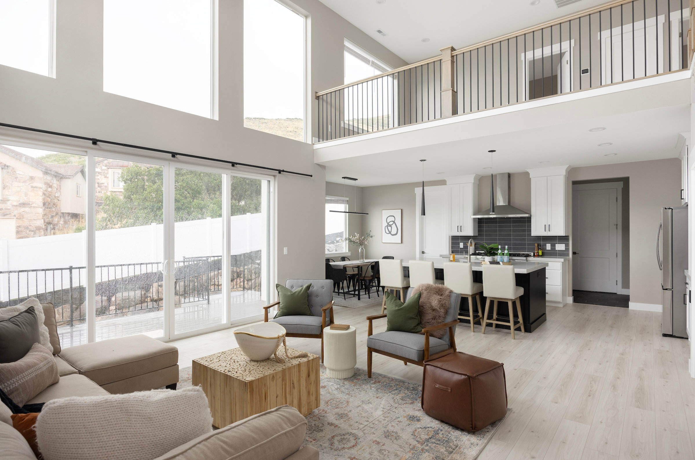 Open-concept living area with soaring ceilings and expansive windows