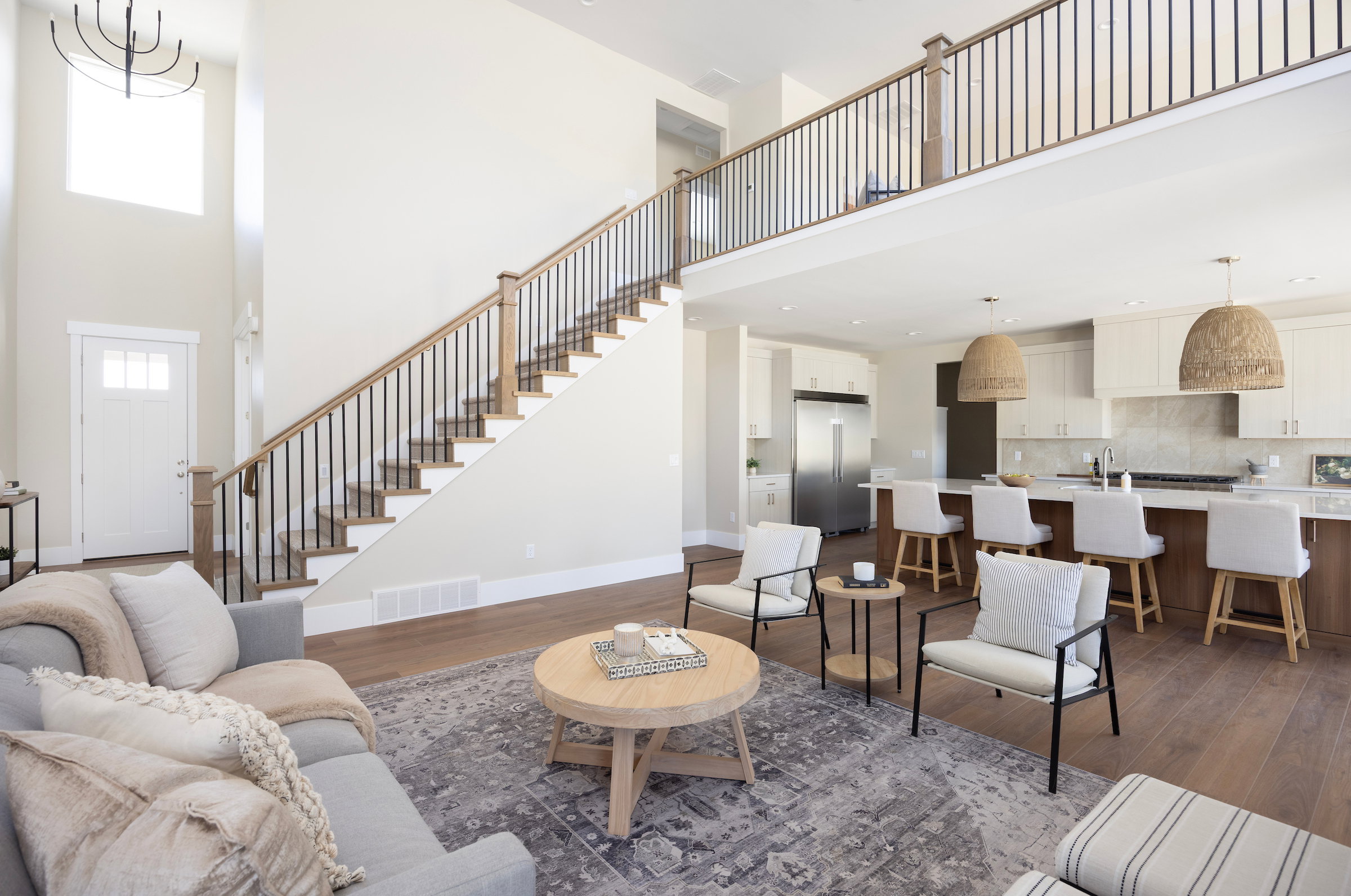 Two-story foyer with a modern chandelier and high ceilings