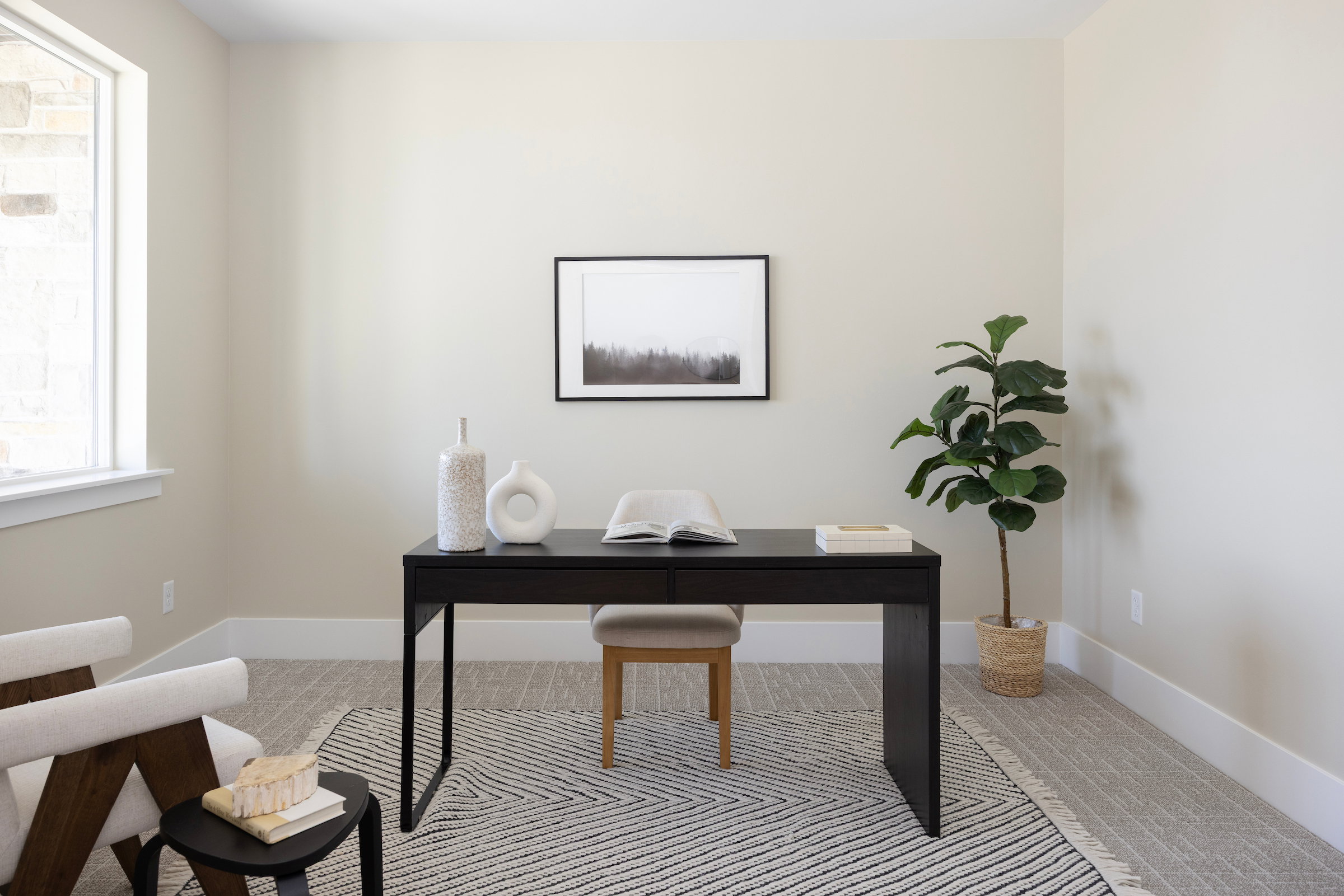 Bright room with light-toned walls and plush carpeting