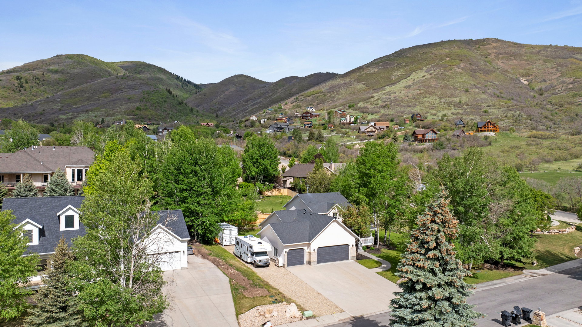 Suburban residential area with green, tree-covered hillsides