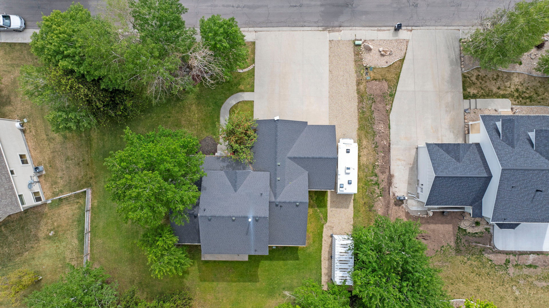 Expansive asphalt driveway with concrete entry