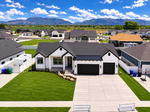 Modern farmhouse exterior with white vertical siding and black trim accents