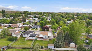 Aerial community perspective featuring residential properties, mature trees, and mountainous terrain in the distance