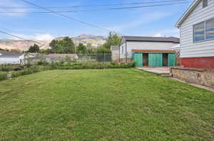 Expansive green lawn with a chain-link fence border