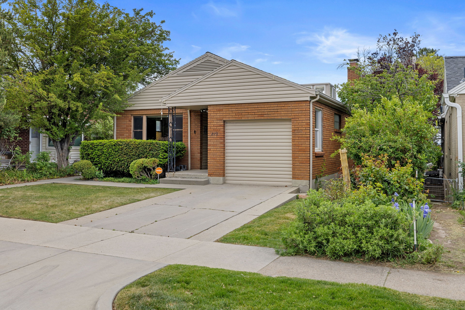 Brick facade home with an attached single-car garage and a concrete driveway