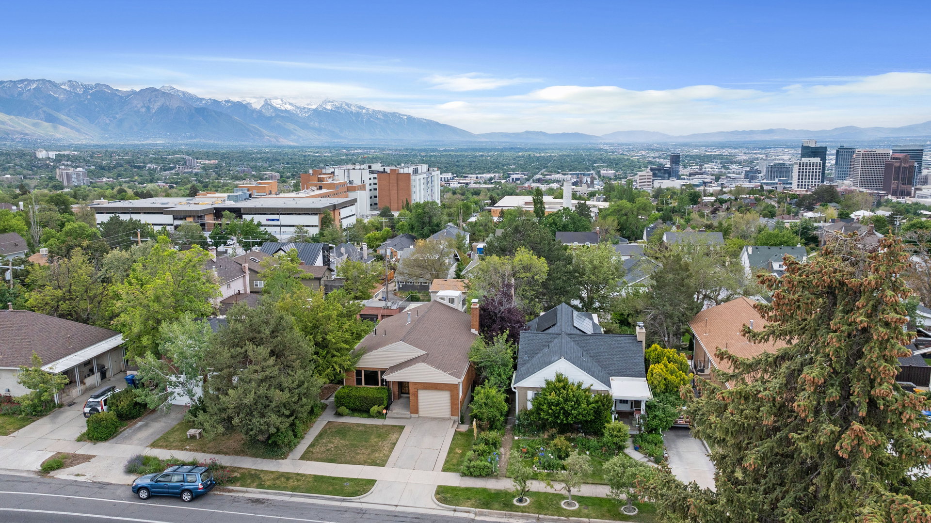 Aerial perspective showcasing residential properties with a mountainous backdrop
