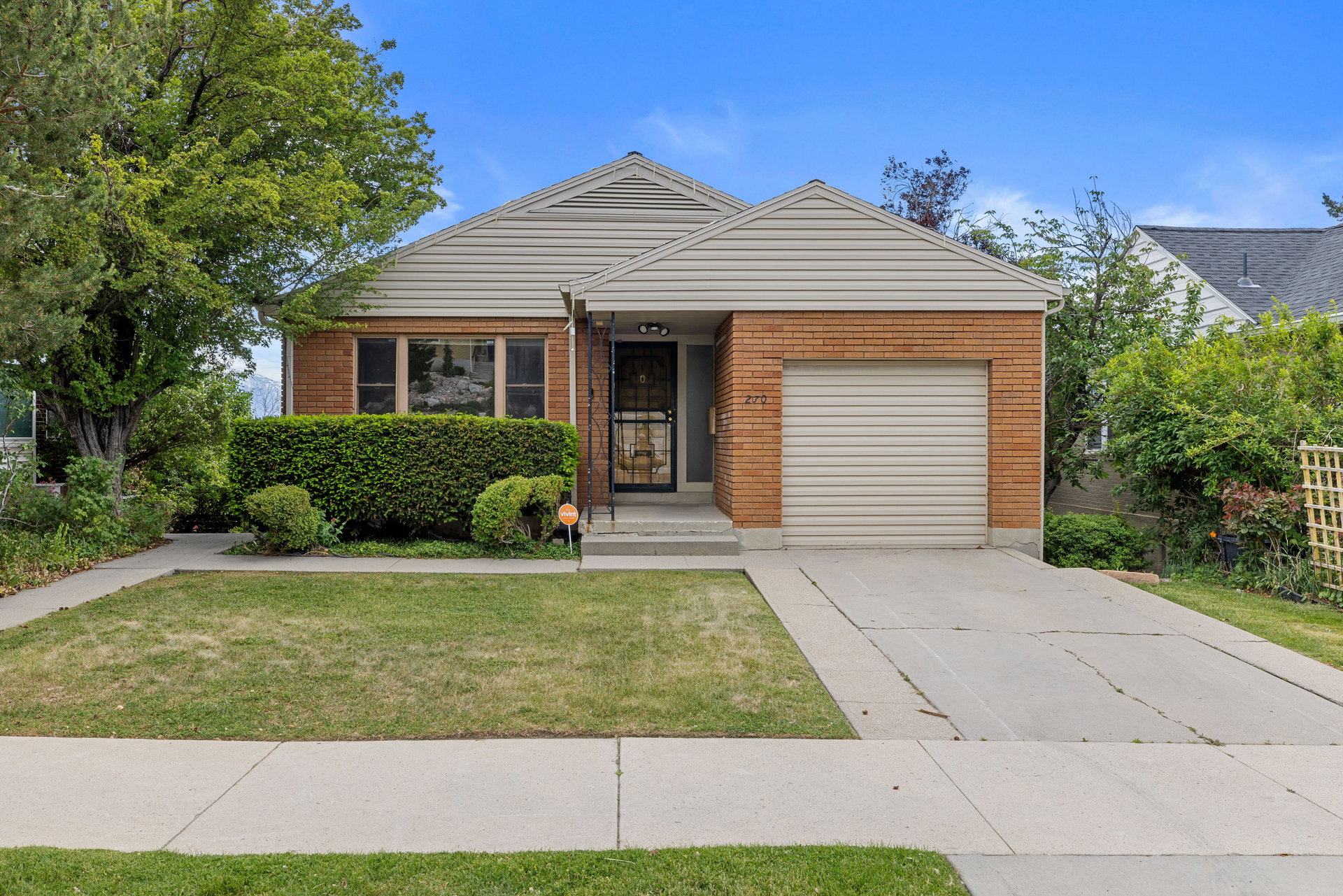 Brick and siding exterior with a single-car garage and concrete driveway