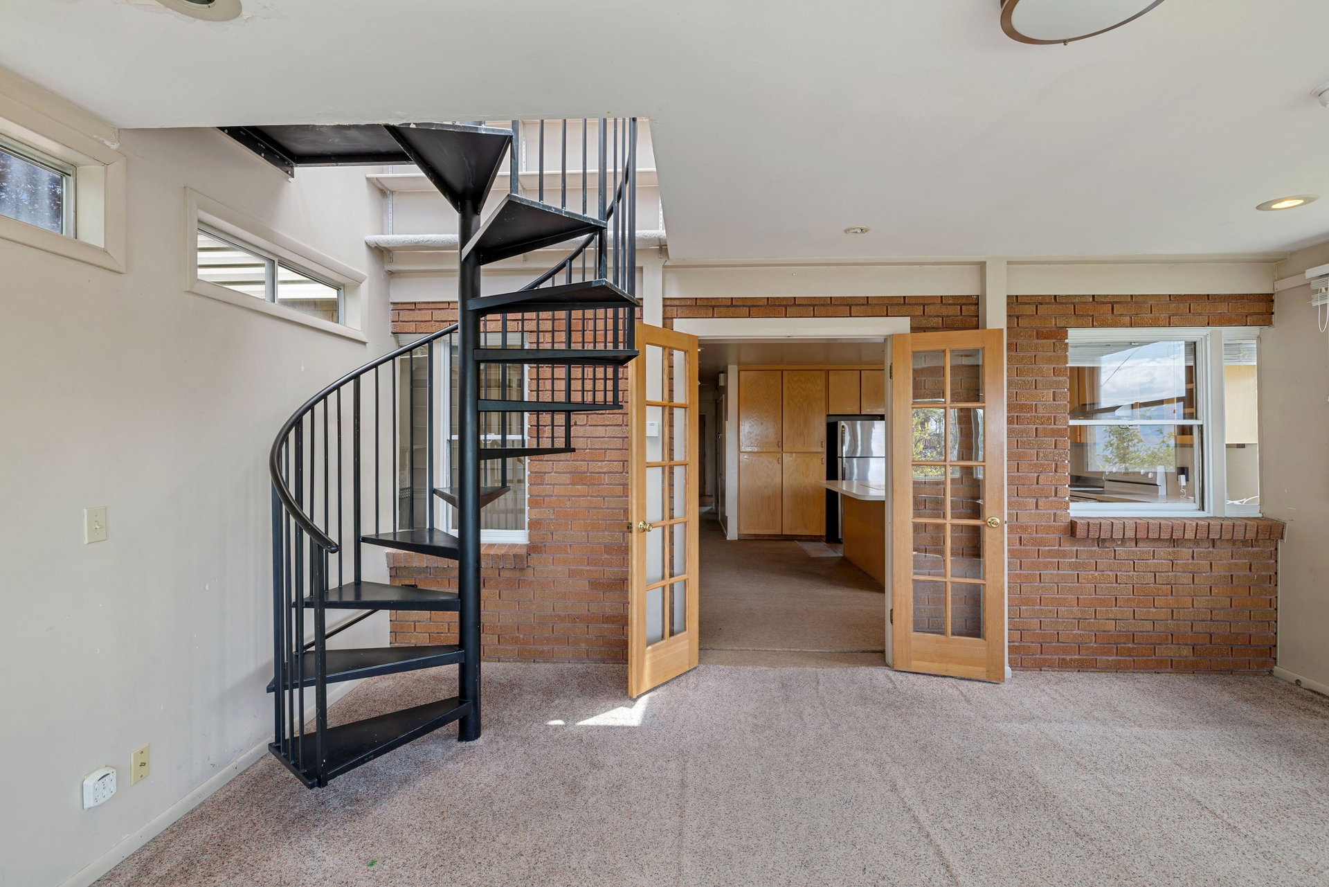 Black metal spiral staircase with a full balustrade