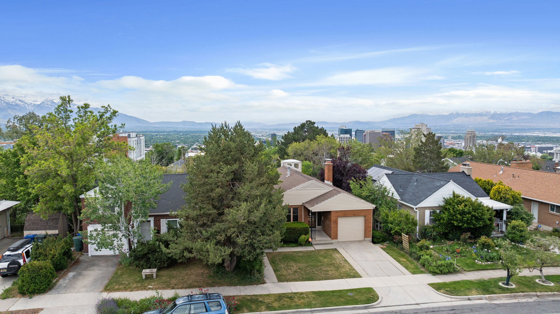 Aerial perspective showcasing a residential neighborhood with distant mountains