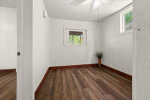 Room featuring wood-finish flooring, white walls, and white trim