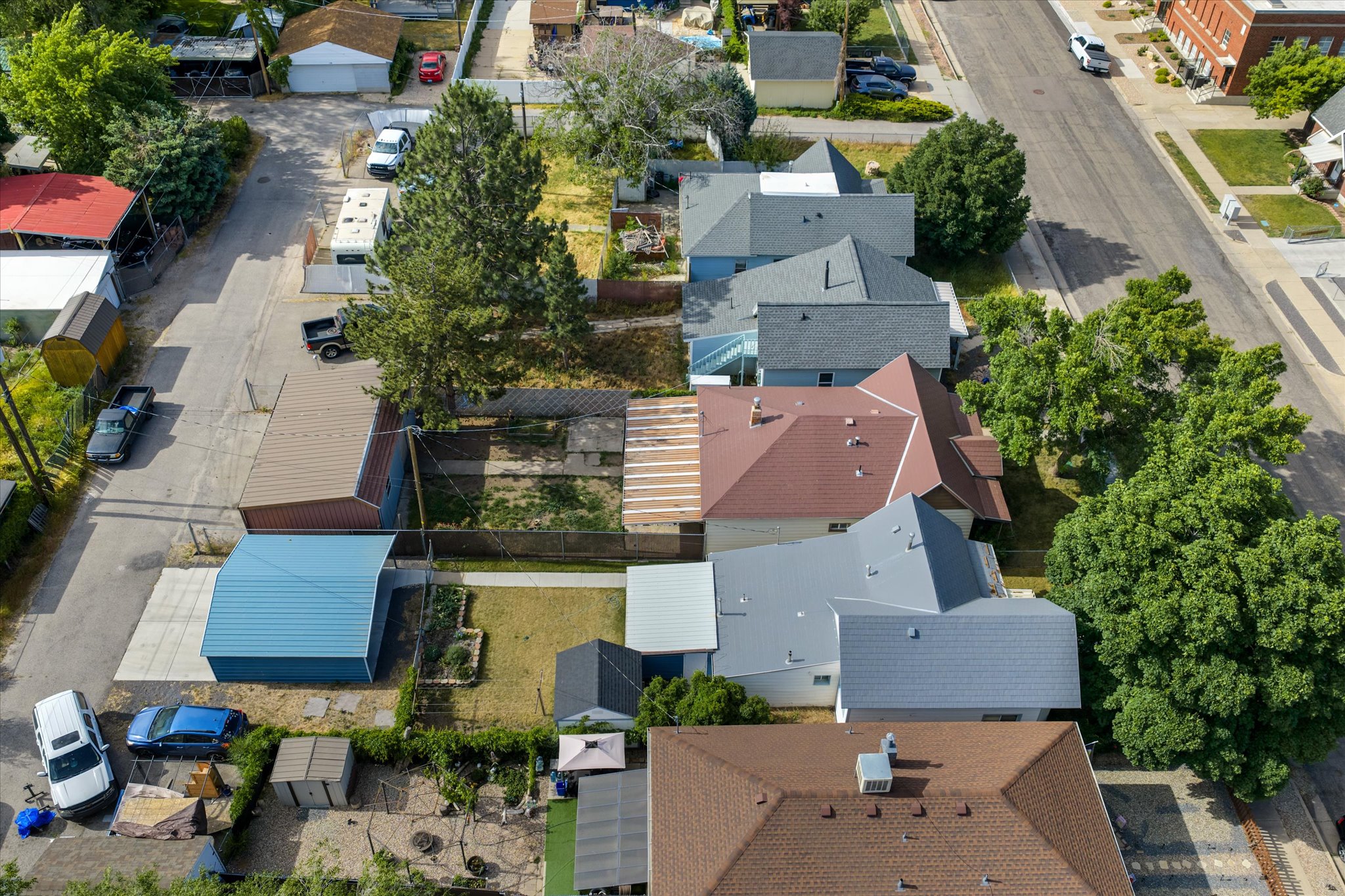 Residential property with a light grey roof and multiple gables