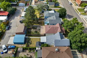 Residential property with a light grey roof and multiple gables