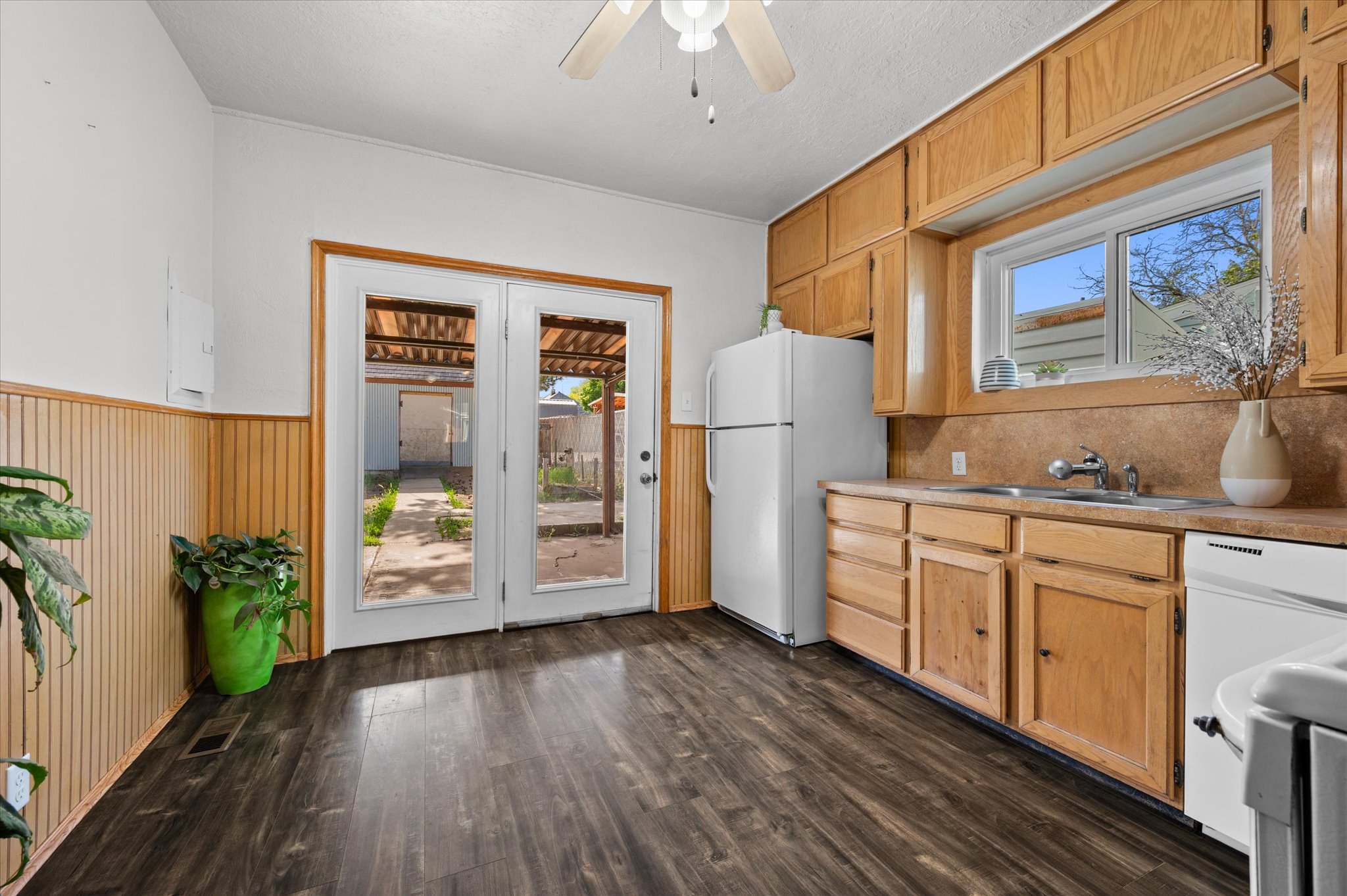 Kitchen featuring wood-finish flooring, wood cabinetry, and a double-basin sink