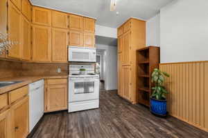 Kitchen featuring wood-finish cabinetry, solid surface countertops, and wood-finish flooring