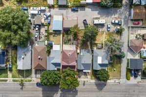 Aerial view showcasing a residential property with a brown-shingled roof