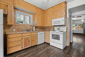 Kitchen featuring wood cabinetry, laminate countertops, a double basin sink, and wood-finish flooring