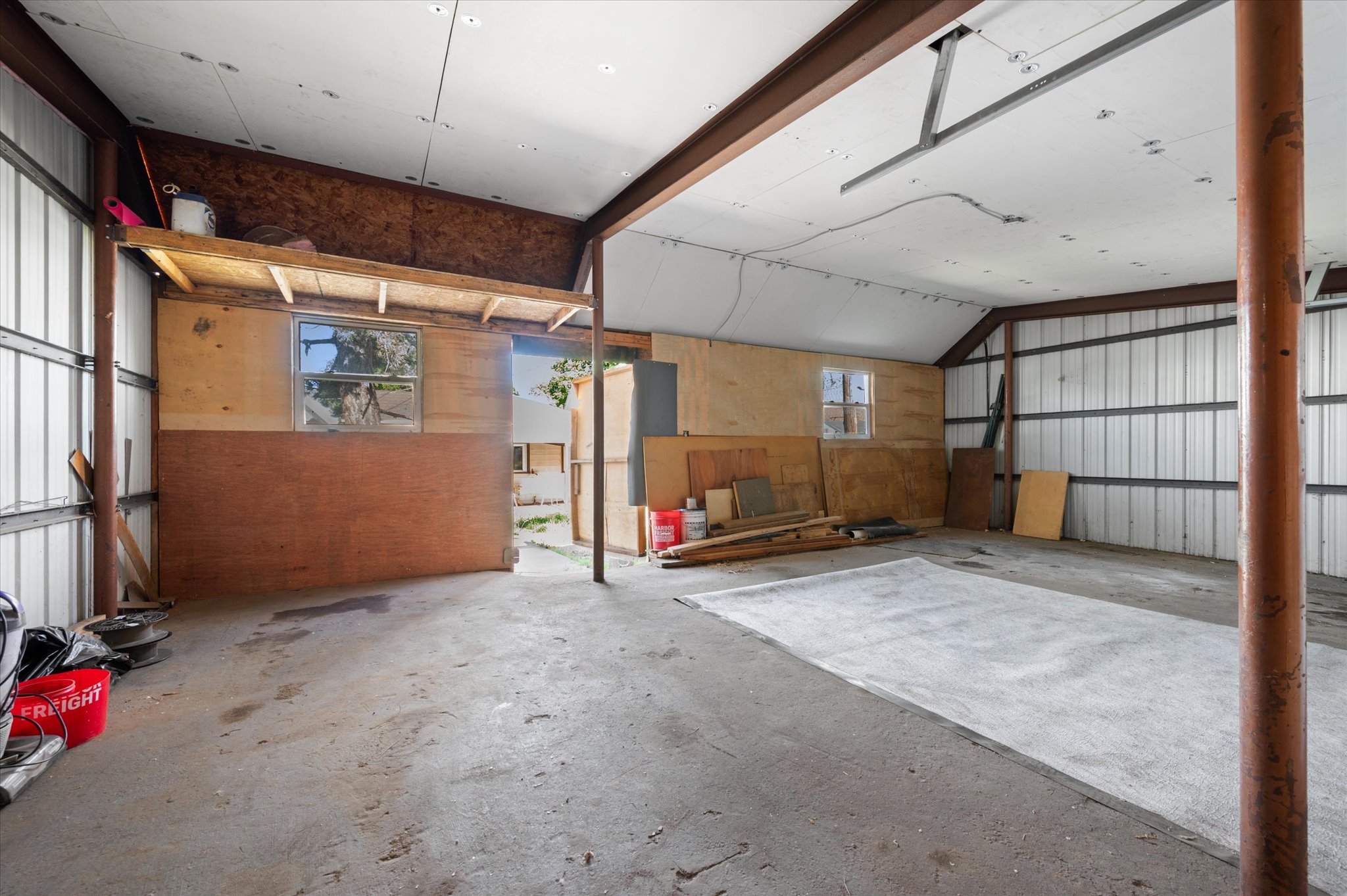 Spacious interior with industrial-style metal walls and exposed structural beams