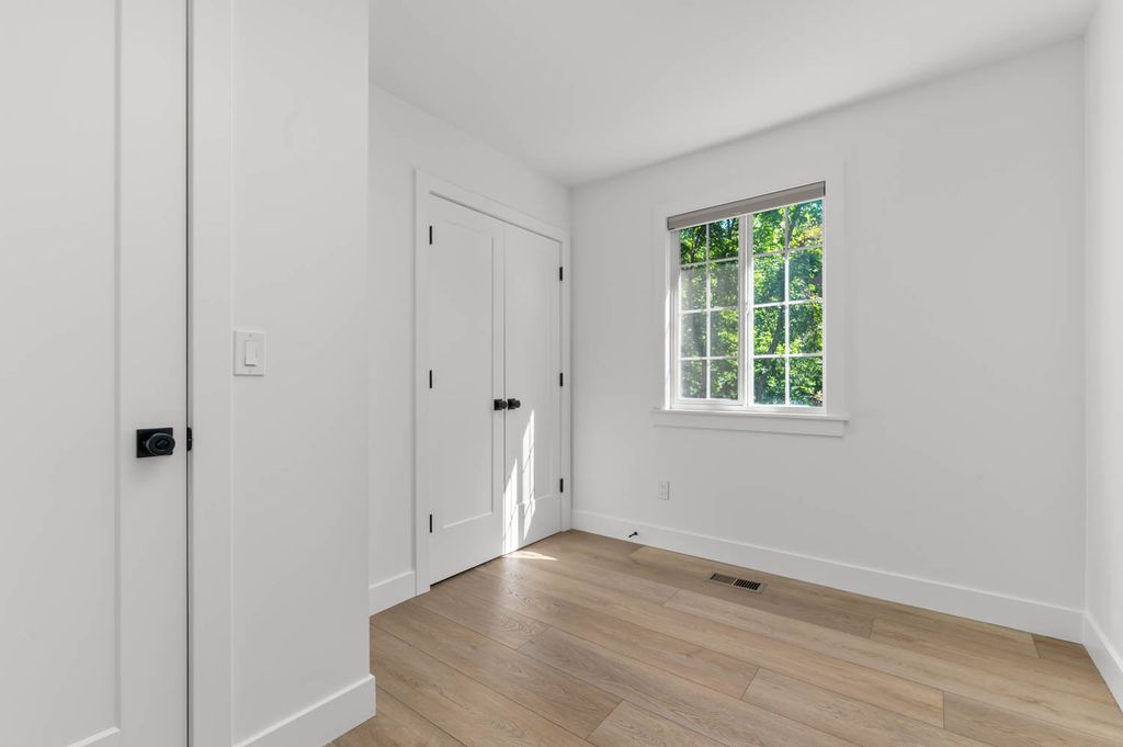 Light wood-finish flooring complements white walls and trim