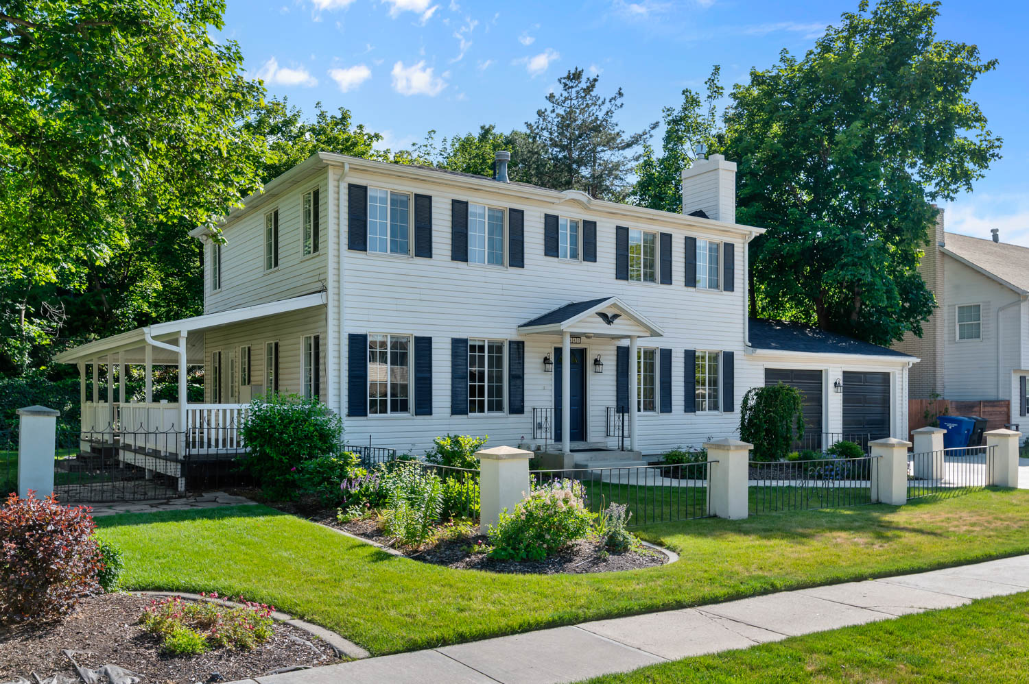 Traditional two-story residence with a covered front entry and a wrap-around porch