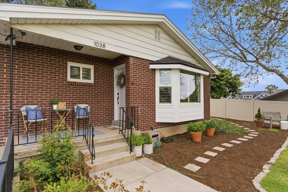 Brick exterior with white siding accents and a prominent bay window