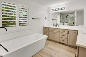 Freestanding soaking tub with dark bronze fixtures