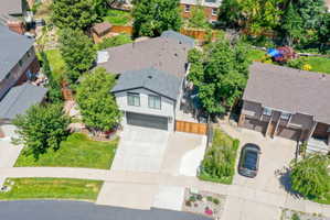 Contemporary exterior with a two-car garage, concrete driveway, and front lawn