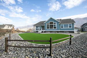Turquoise siding with white trim accents and a dark roof