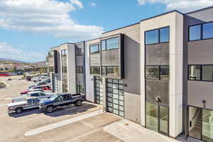 Modern multi-story commercial building featuring a contemporary facade with varied paneling and expansive windows