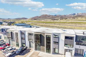Modern multi-level townhomes featuring mixed-material facades with vertical siding and stucco