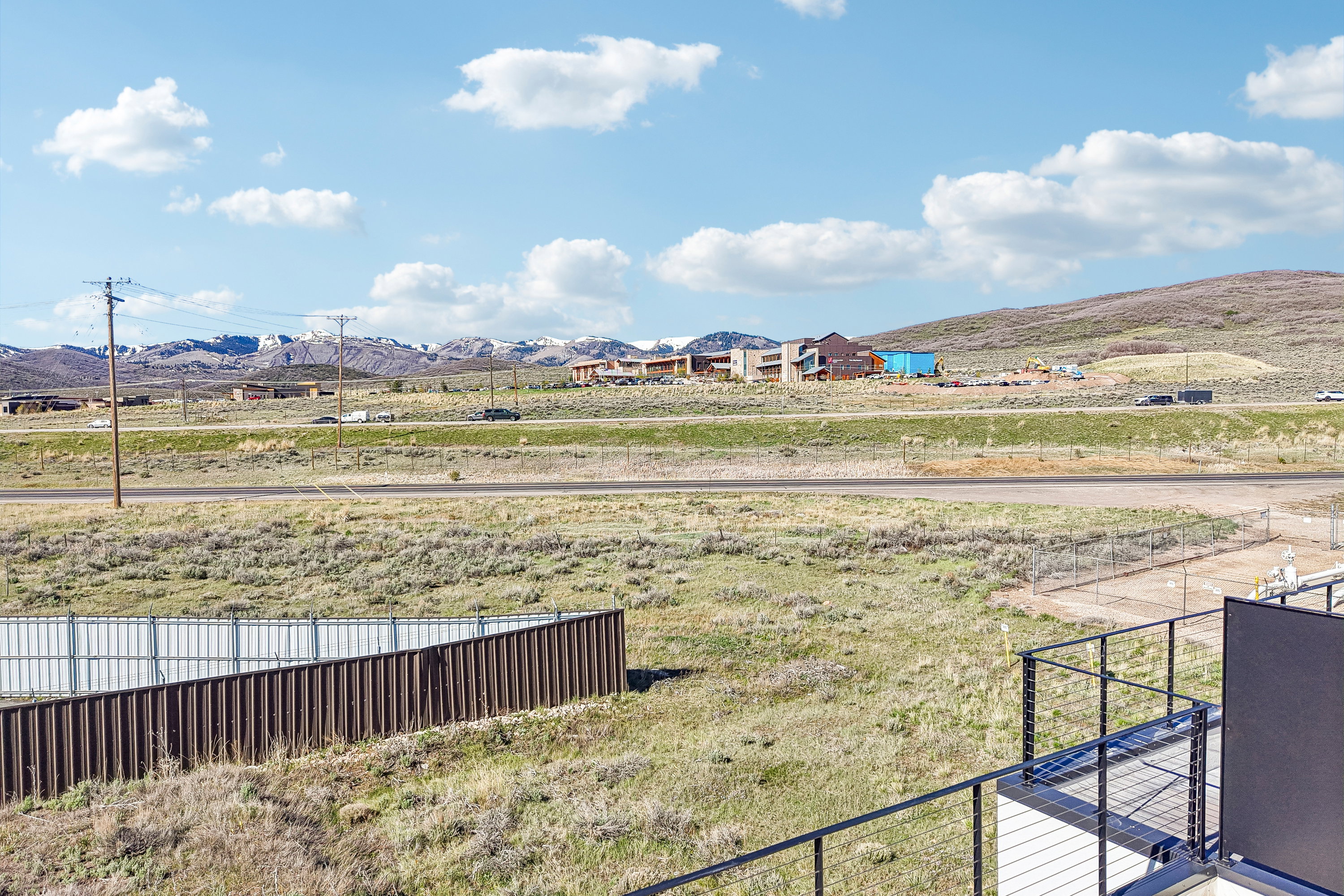Expansive outdoor area with a cable railing system and metal privacy fencing
