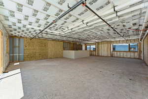Unfinished interior space featuring exposed ceiling insulation and visible plumbing lines