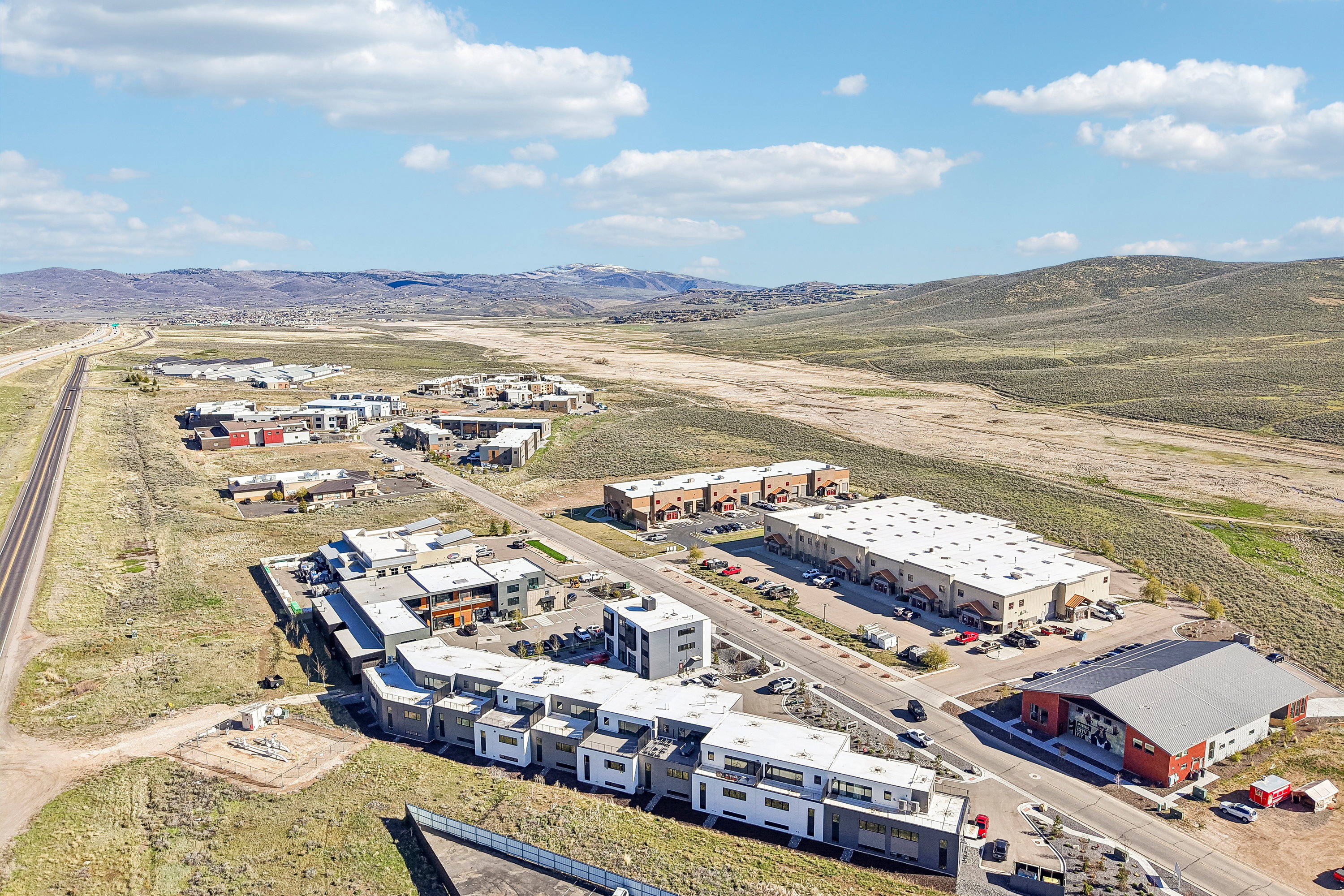 Modern residential and commercial structures situated in a high desert landscape