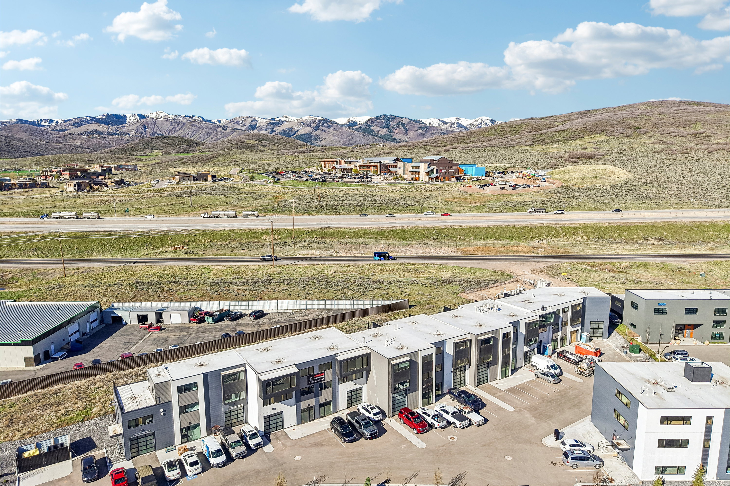 Modern mixed-use development featuring individual garage doors and large windows