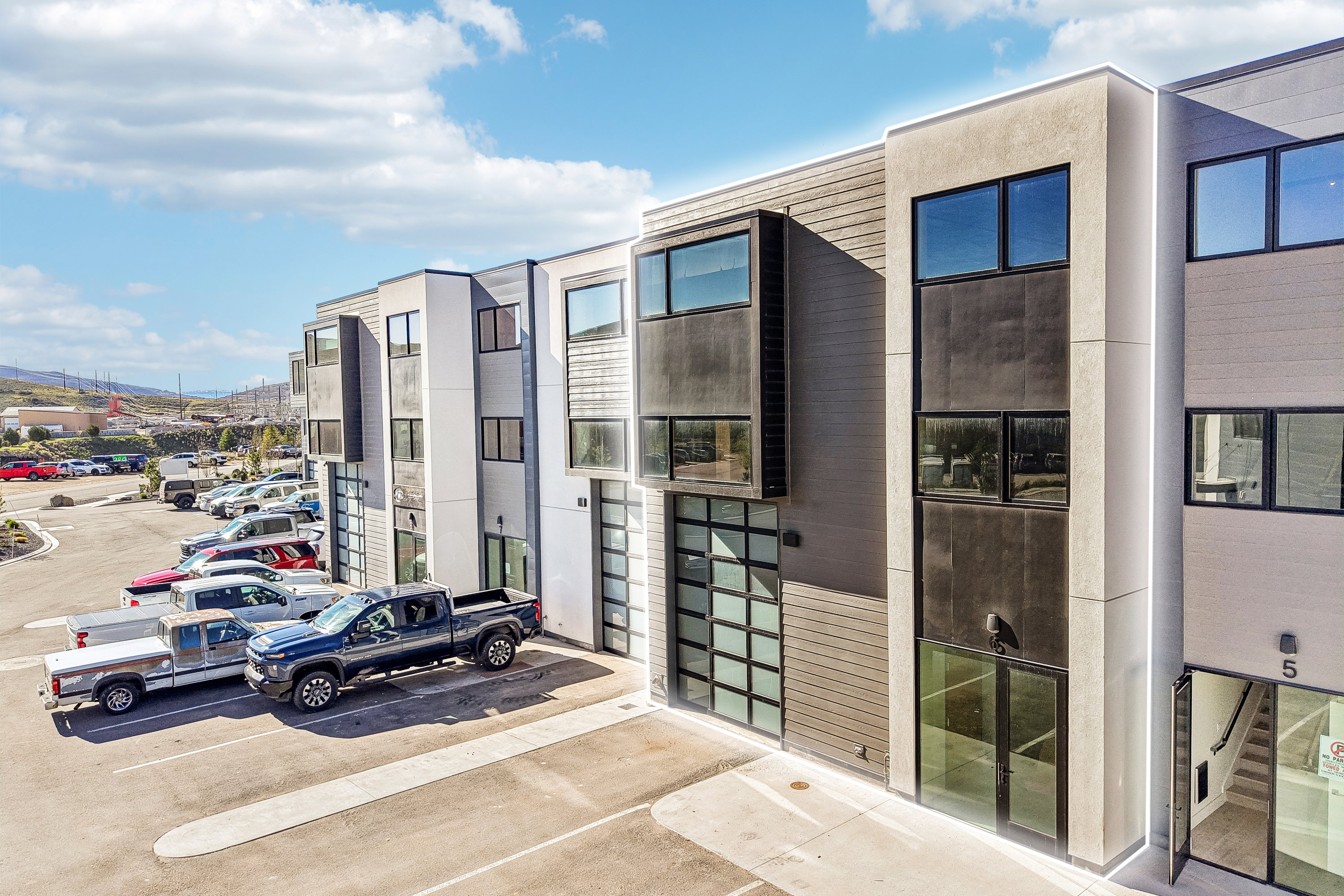 Contemporary architectural design featuring multi-story units with large windows