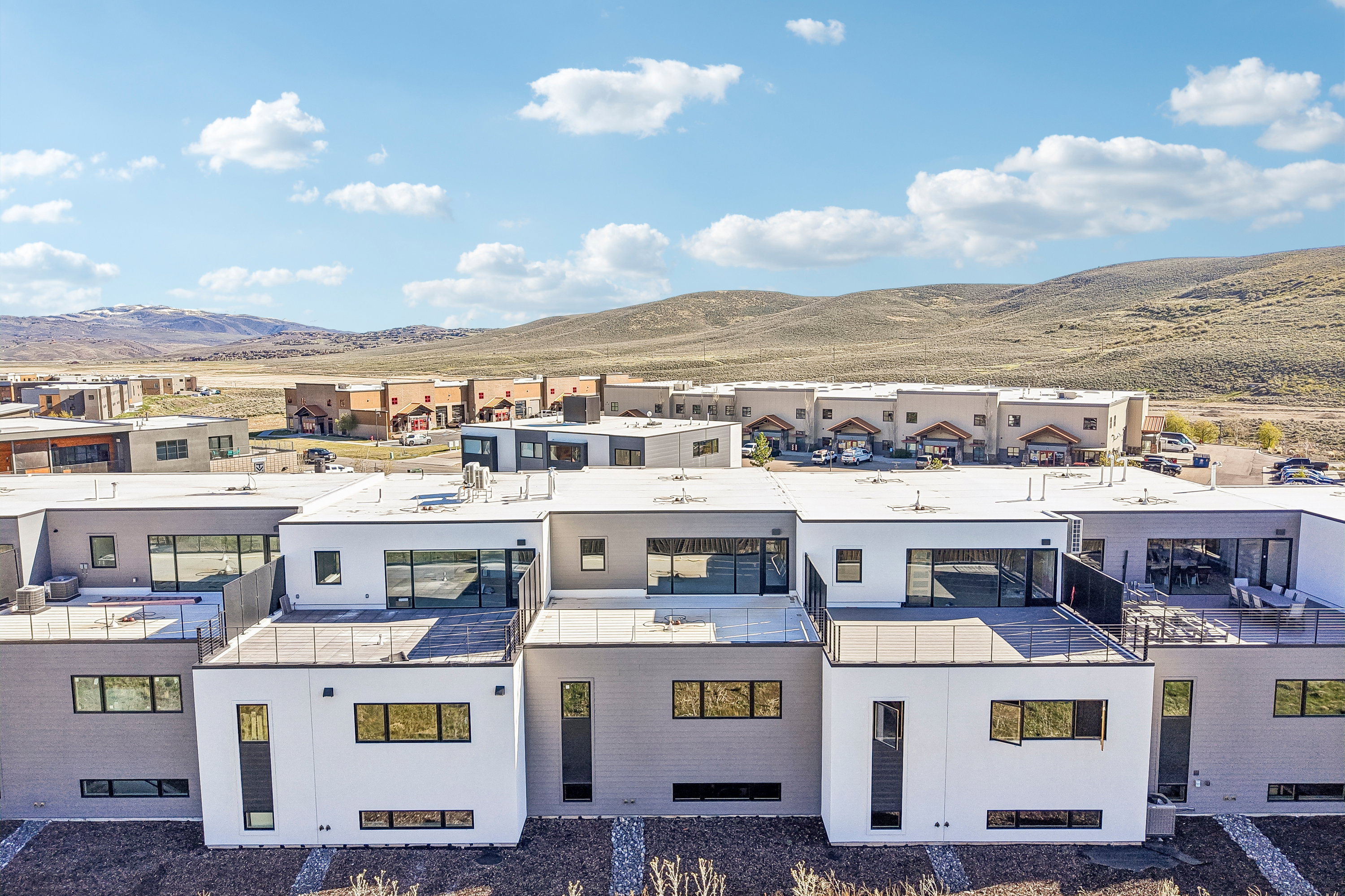 Contemporary multi-story residences featuring flat roofs and expansive outdoor deck spaces