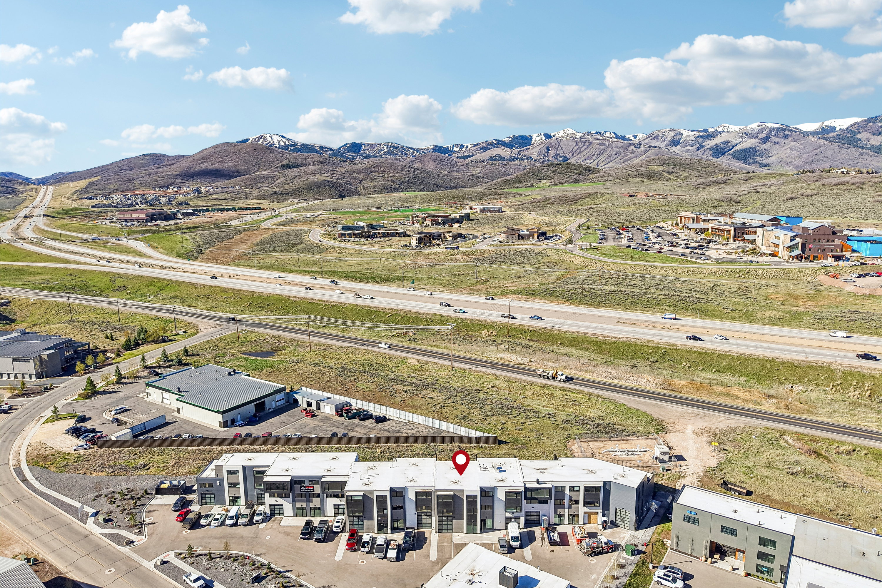 Modern multi-unit building featuring a flat roofline and integrated parking