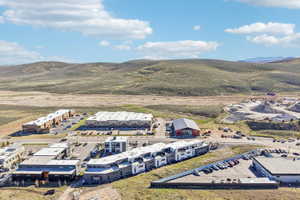 Aerial perspective showcasing diverse commercial and residential structures amidst natural terrain