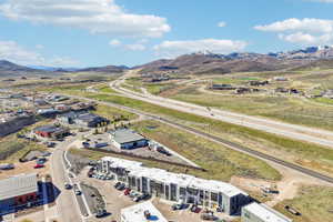 Aerial perspective showcasing multiple commercial buildings and a modern multi-unit structure