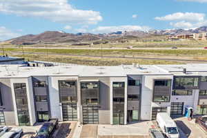 Contemporary multi-story buildings featuring a flat roofline and dark-framed windows