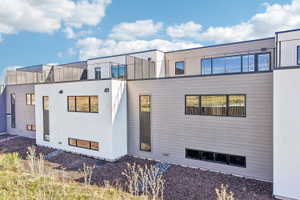 Contemporary multi-level exterior featuring white and gray horizontal siding