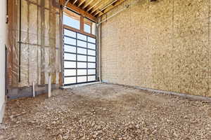 Full-panel glass garage door featuring a black frame
