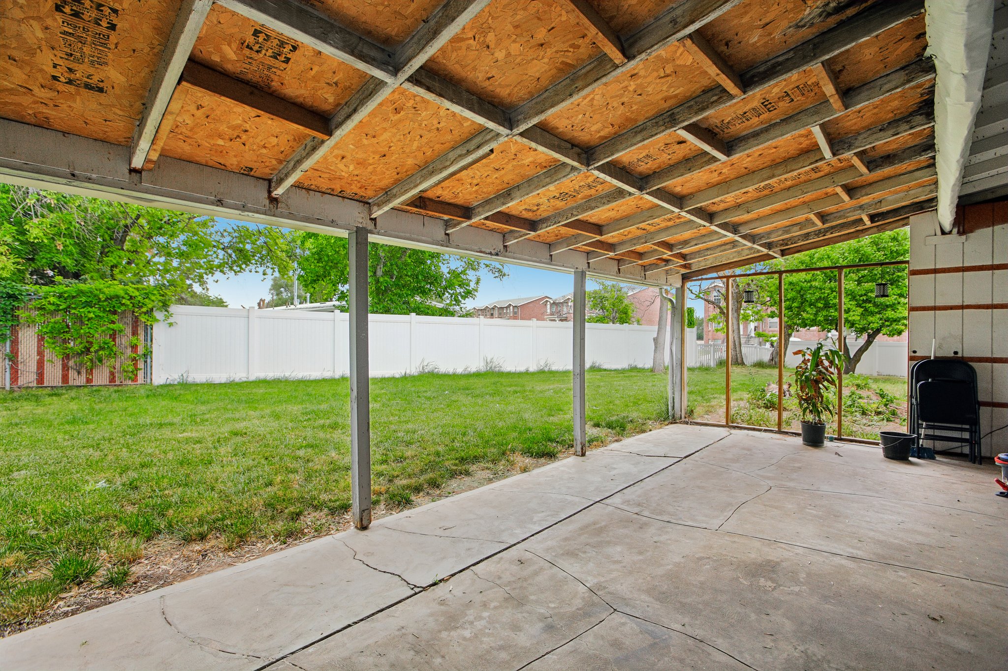 Covered patio featuring a concrete slab and exposed wood ceiling