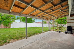 Covered patio featuring a concrete slab and exposed wood ceiling