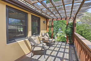 Expansive wood deck with a slatted pergola overhead