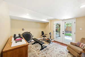 Bright room featuring white French doors with integrated glass panels, recessed ceiling lighting, and light-toned walls